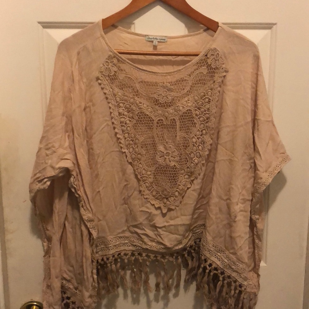A light creamy salmon top with blue jeans
